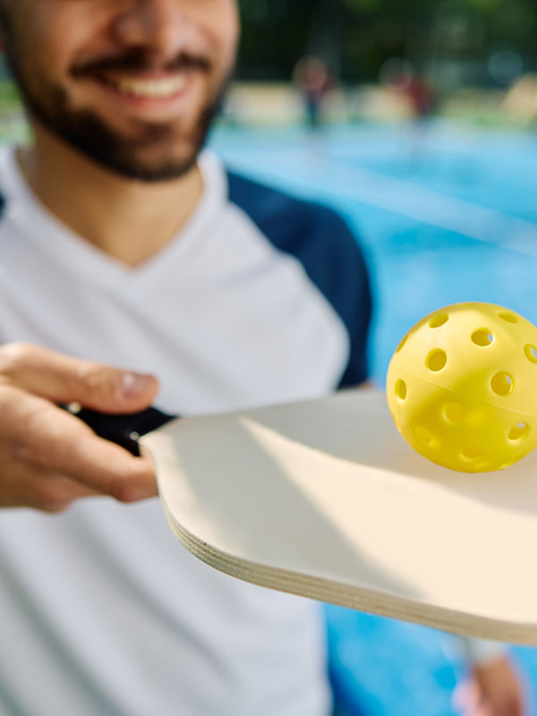 Close Up Of Athletic Man Plays Pickleball.